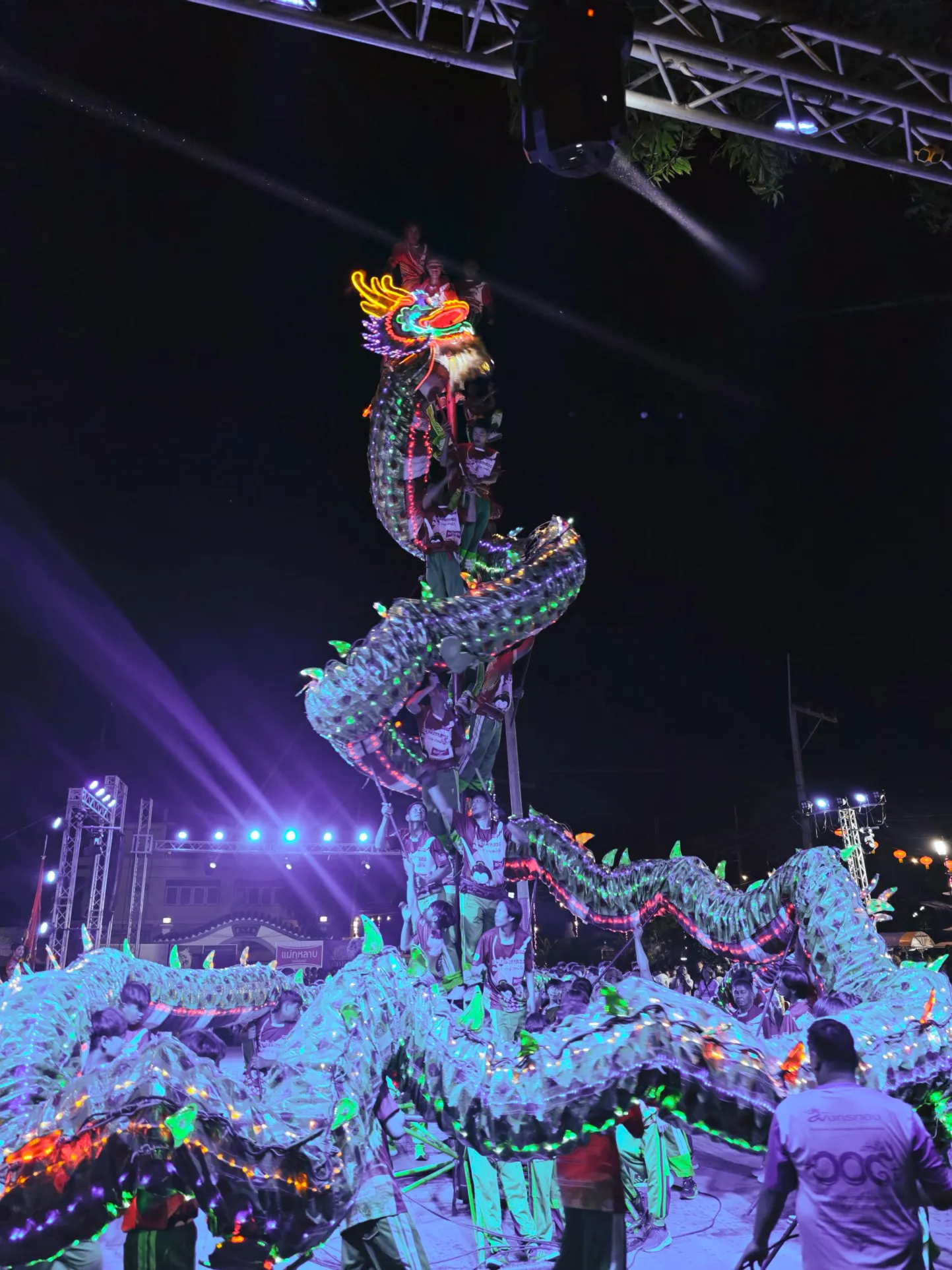 a dragon wraps itself up around a pole as it chases a lantern
