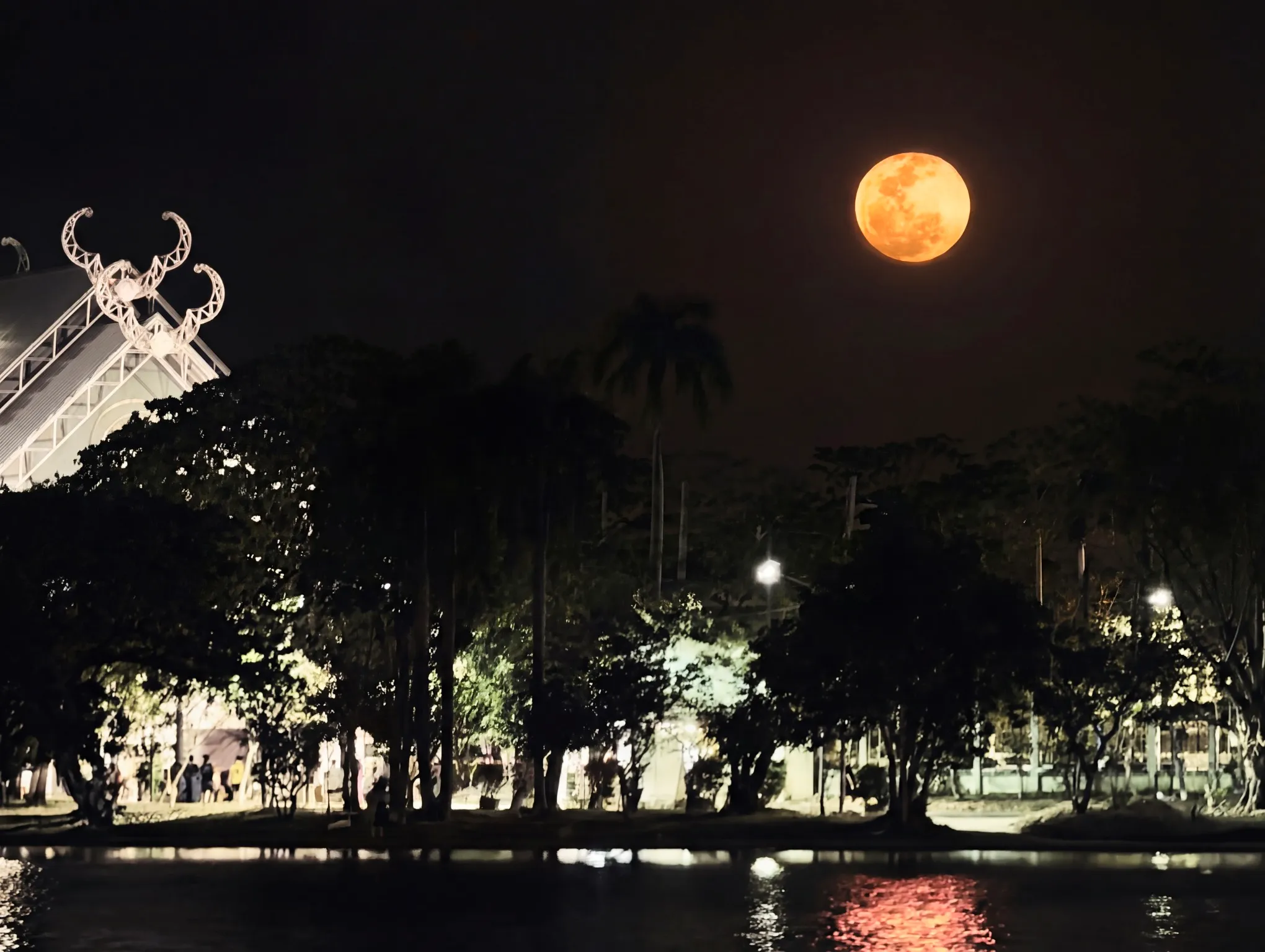 a blood moon hanging over nong somboon lake at night