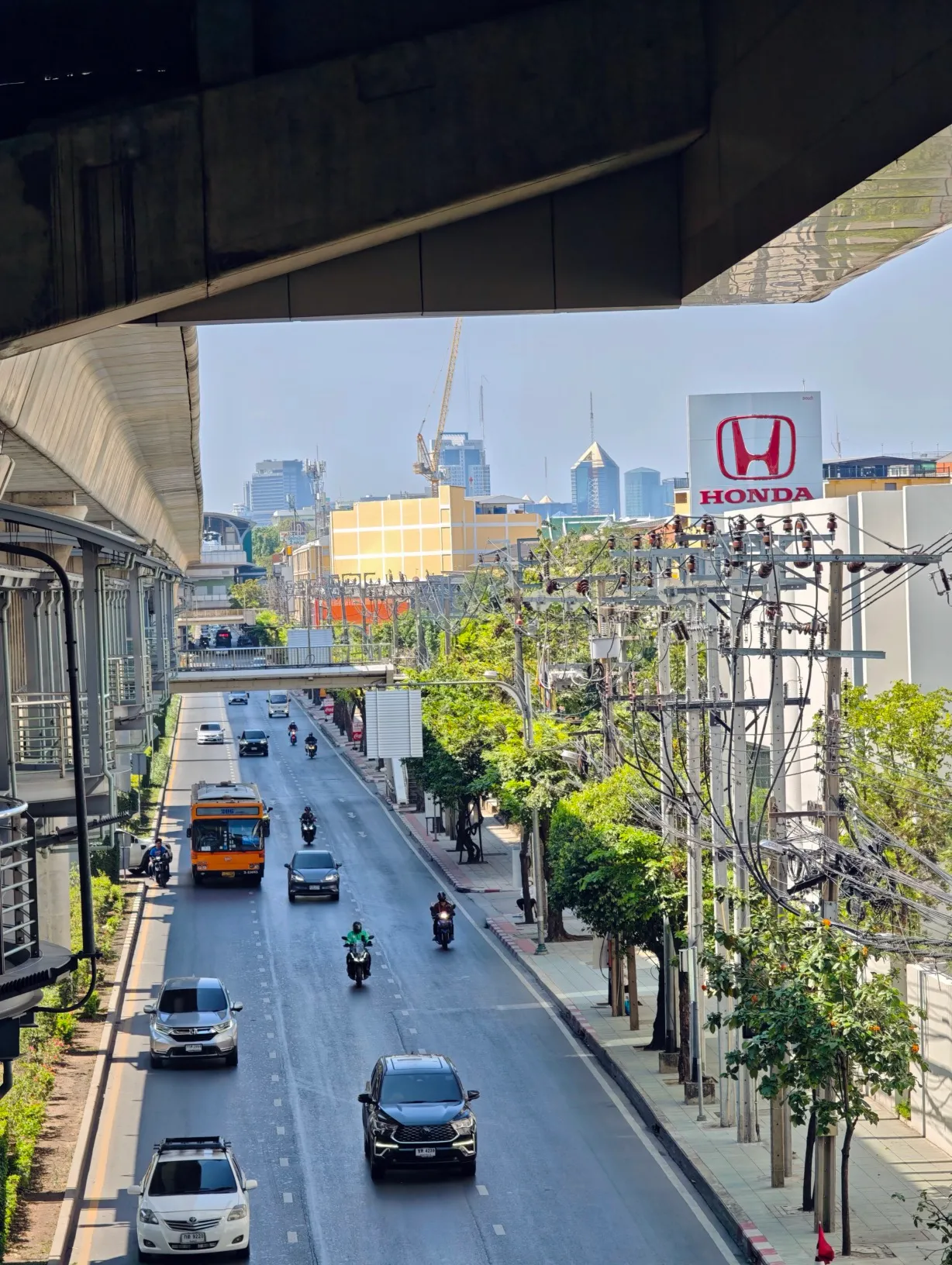 the view out into the bankok suburbs from under the skytrain bridge